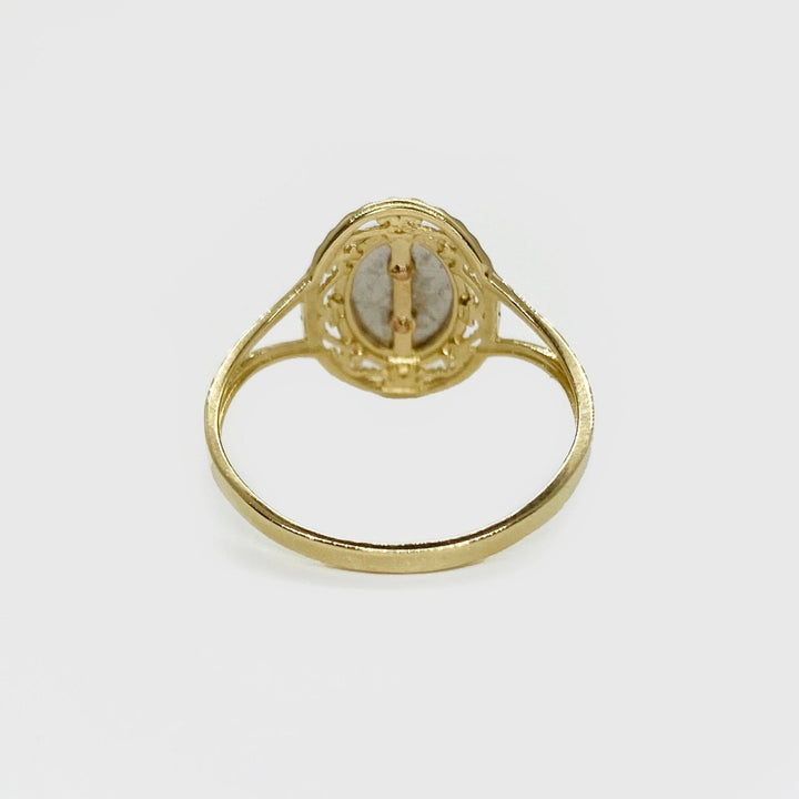 14k Gold ring with a oval shape design back view on a white background.