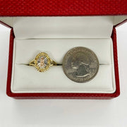 14k Gold oval ring with virgin mary design with a quarter coin for scale.