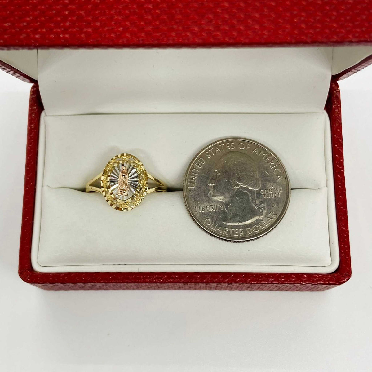14k Gold oval ring with virgin mary design with a quarter coin for scale.