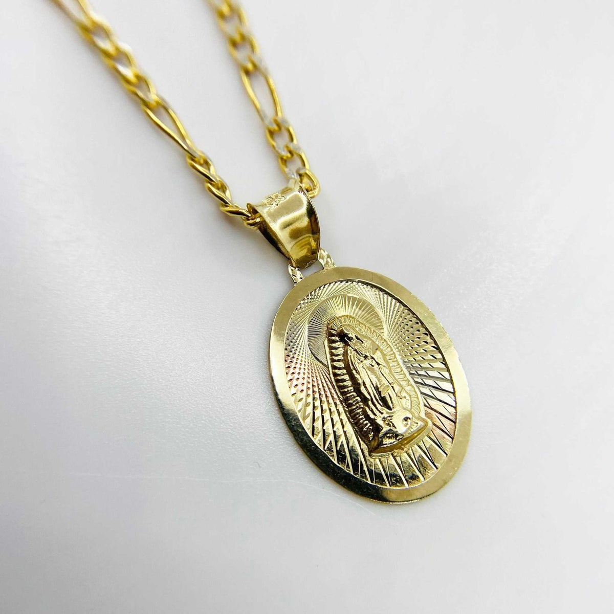 Gold Virgin Mary medal pendant featuring Our Lady of Guadalupe motif with polished border