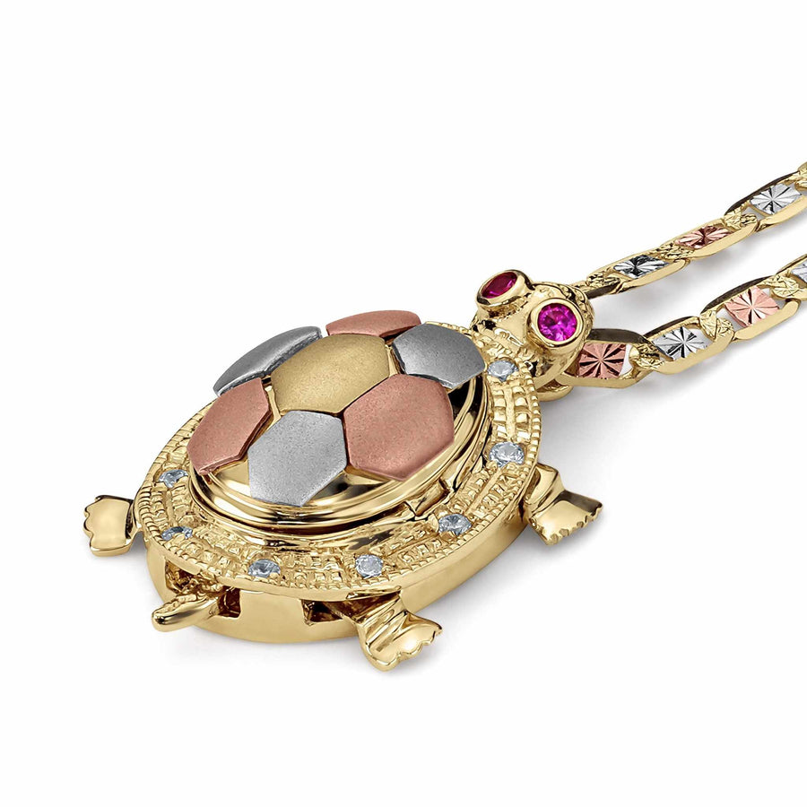 Tricolor gold tortoise pendant necklace with cubic zirconia accents and red cubic zirconia eyes.