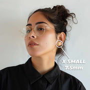 Woman wearing 14k yellow and rose gold Guadalupe heart stud earrings for scale.