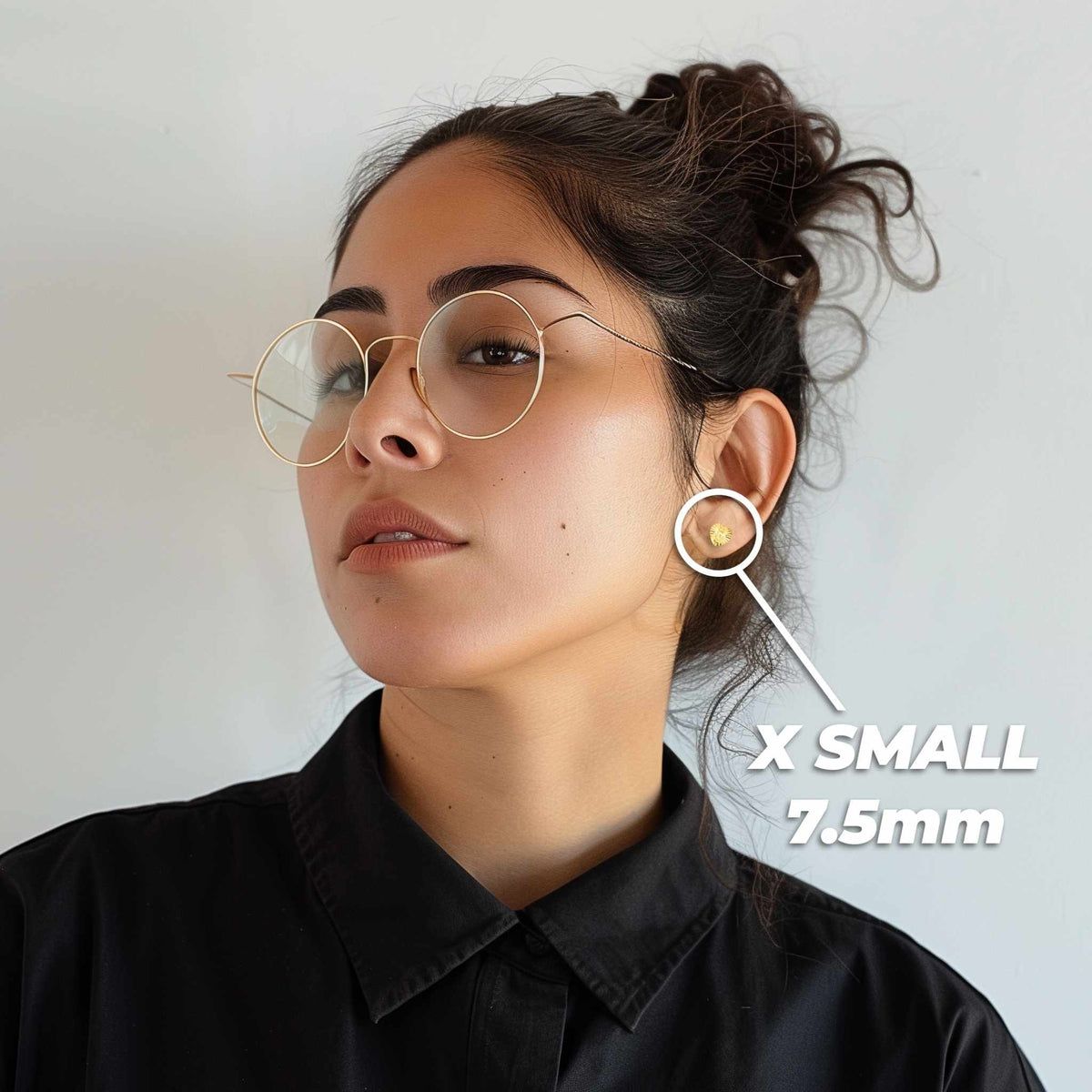 Woman wearing 14k yellow and rose gold Guadalupe heart stud earrings for scale.