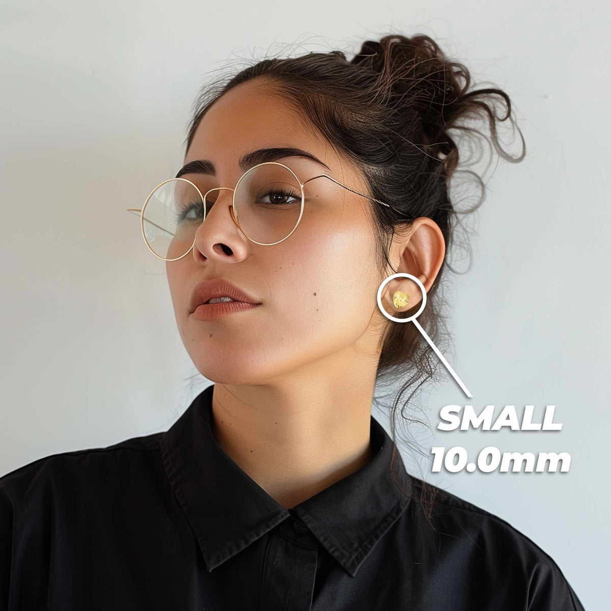 Woman wearing 10.0mm small 14k gold Guadalupe heart stud earrings for size reference.