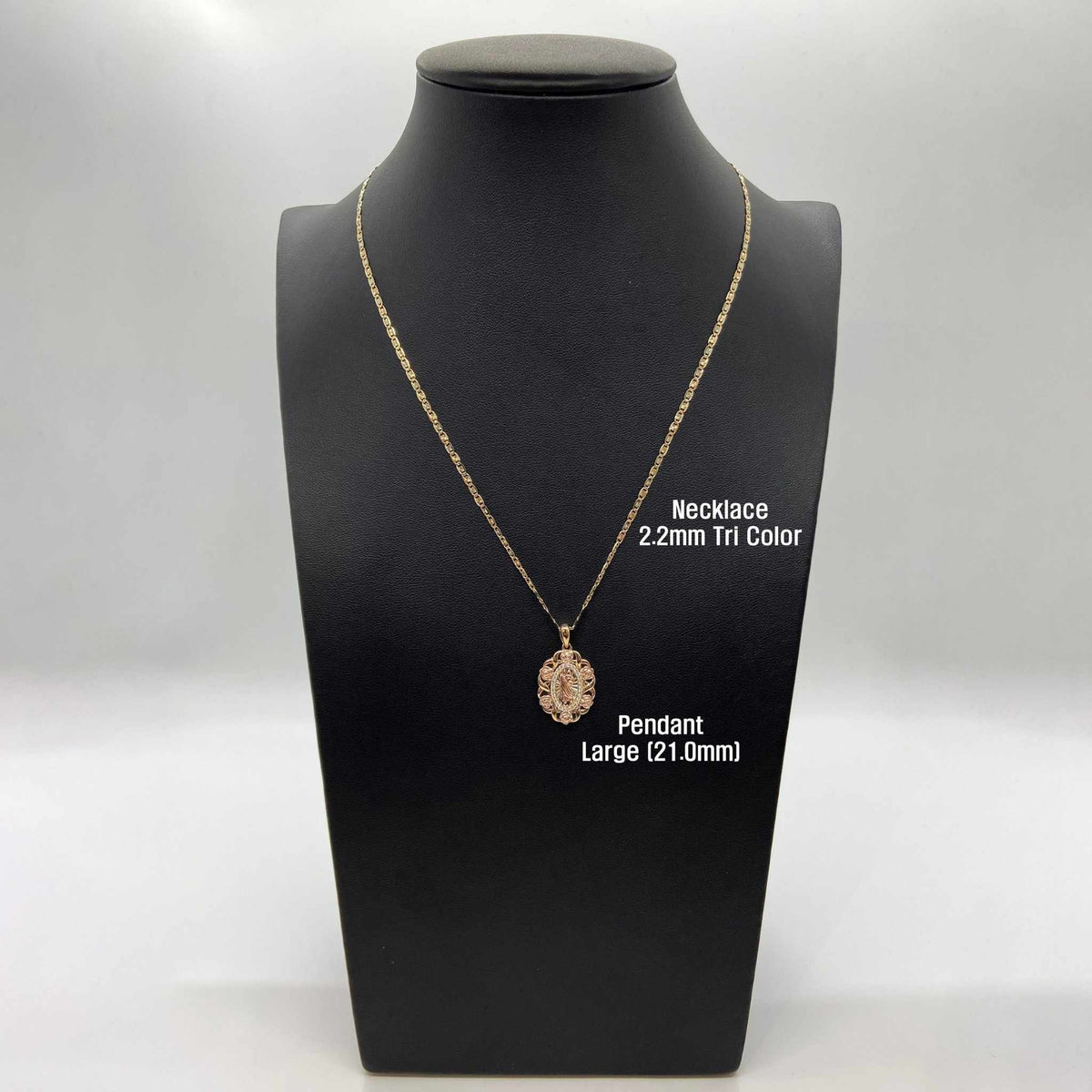 Gold oval pendant necklace on a mannequin display labeled Large 21.0mm and 2.2mm tri-color chain.