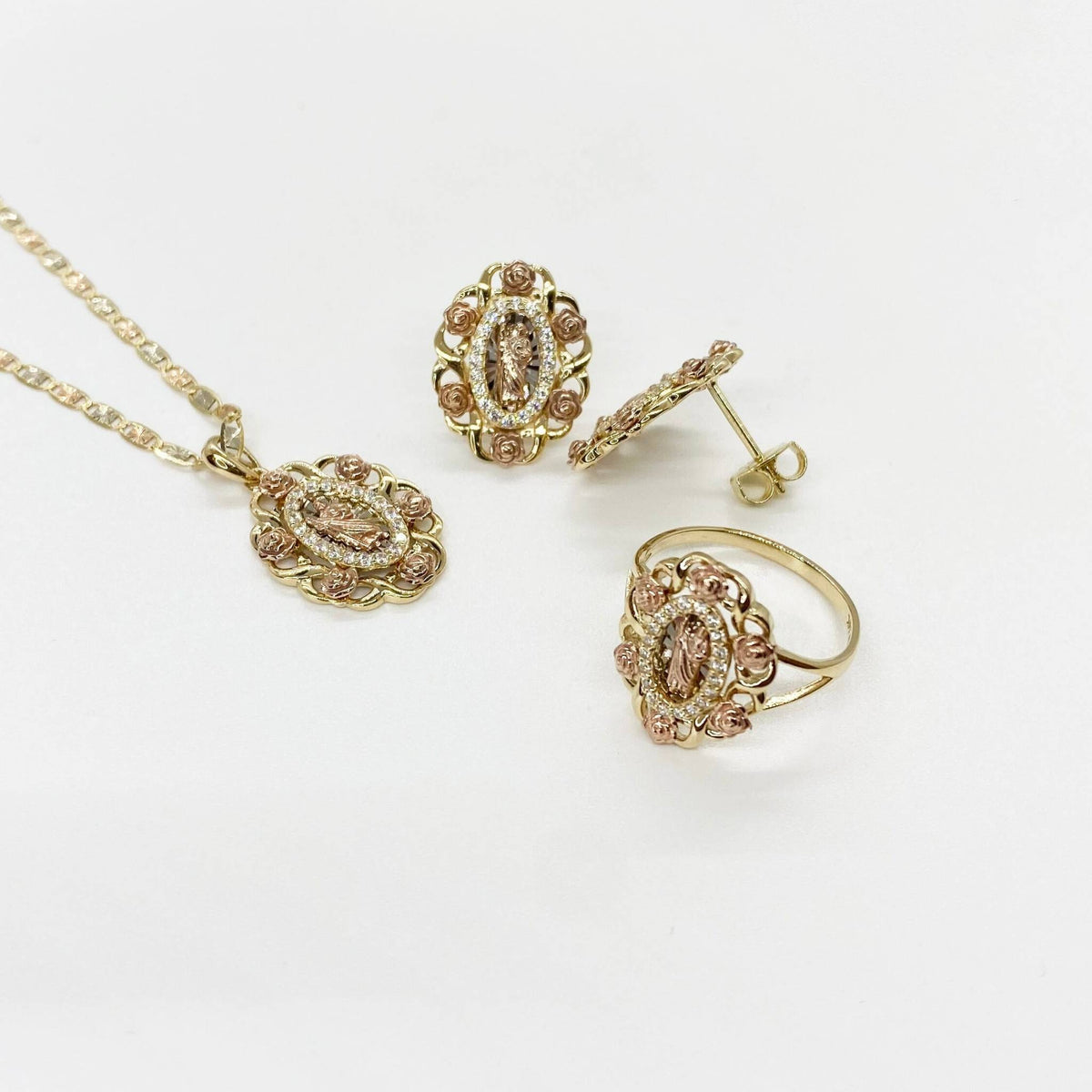 Matching 14k tri-color gold Saint Jude jewelry set including necklace, ring, and stud earrings.