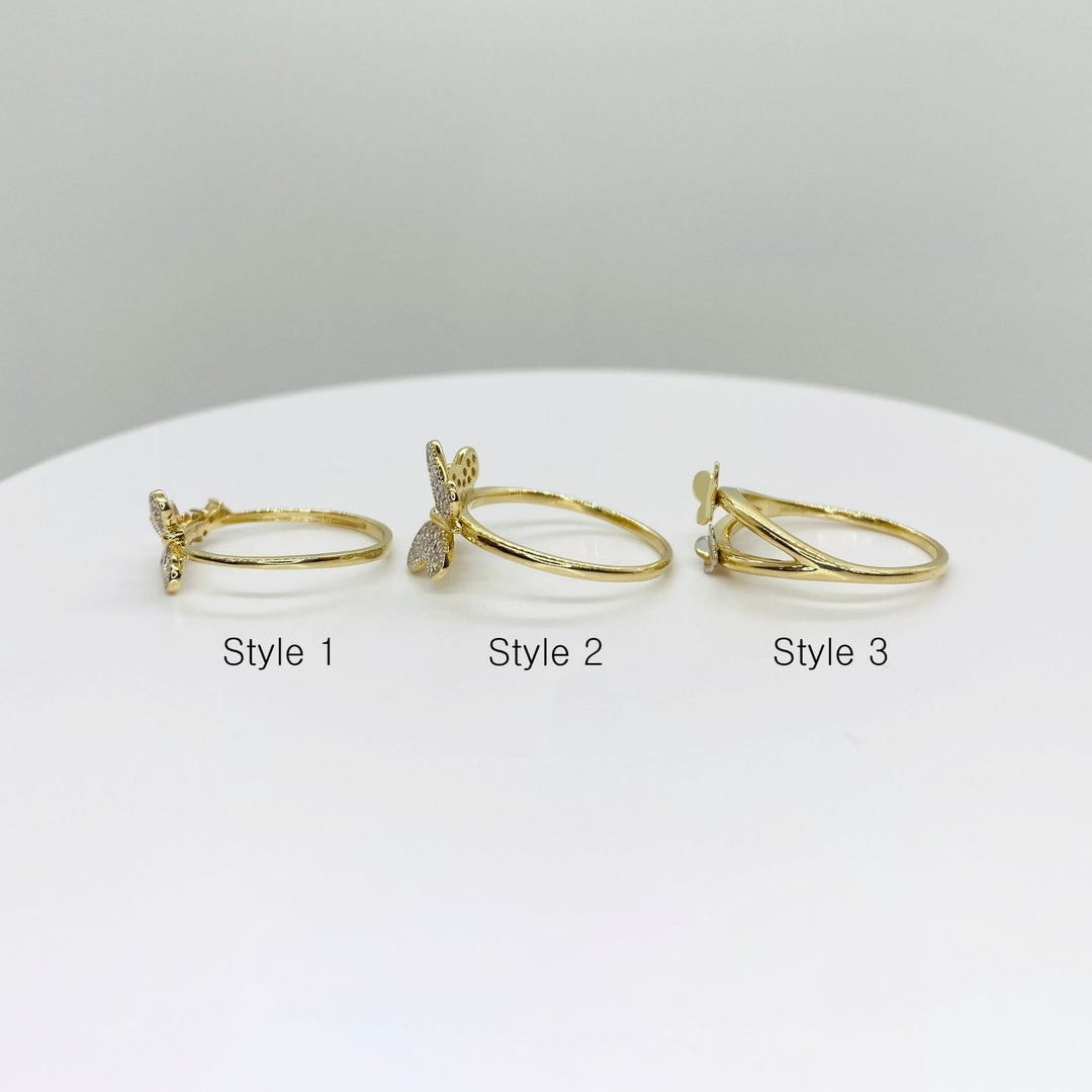 Three 14k gold rings with three different butterfly design side view 