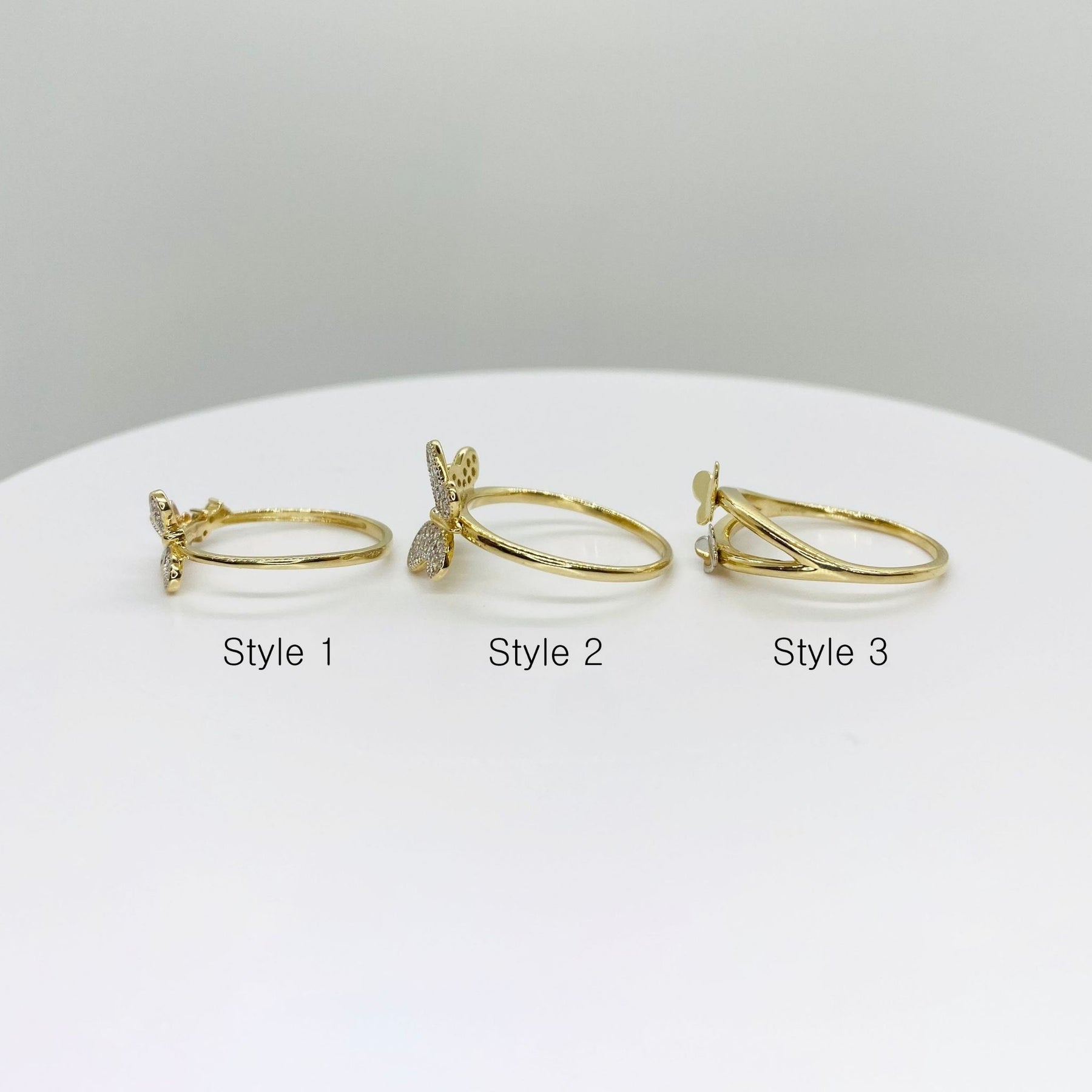 Three 14k gold rings with three different butterfly design side view 