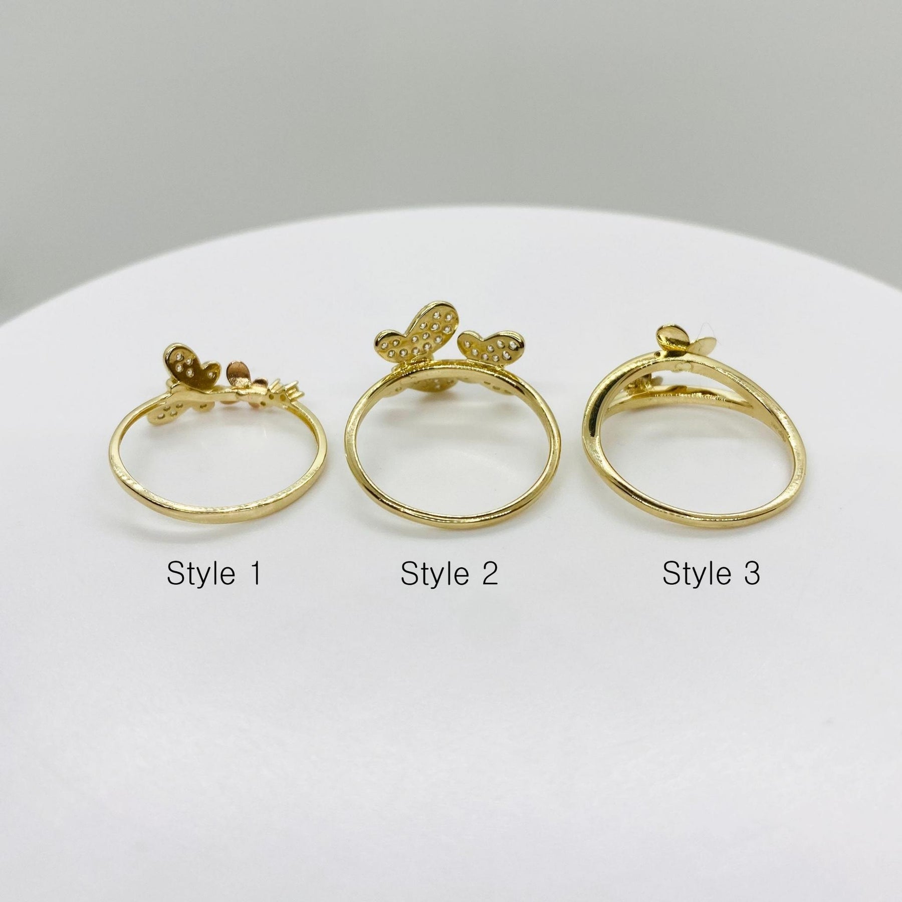 Three 14k gold butterfly ring back view  labeled Style 1, Style 2, and Style 3