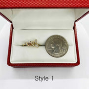 14k Gold ring with butterfly design in a red jewelry box next to a quarter for comparison