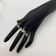 Black mannequin hand wearing three different styles of 14k gold butterfly rings