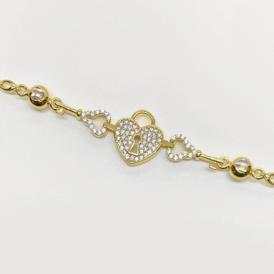 14k gold heart lock and key charm bracelet with pave cubic zirconia accents.