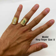 Hand wearing two 14k gold rings with  San Judas design white background.