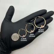 14k gold Virgin Mary hoop earrings in three sizes shown with a U.S. quarter.