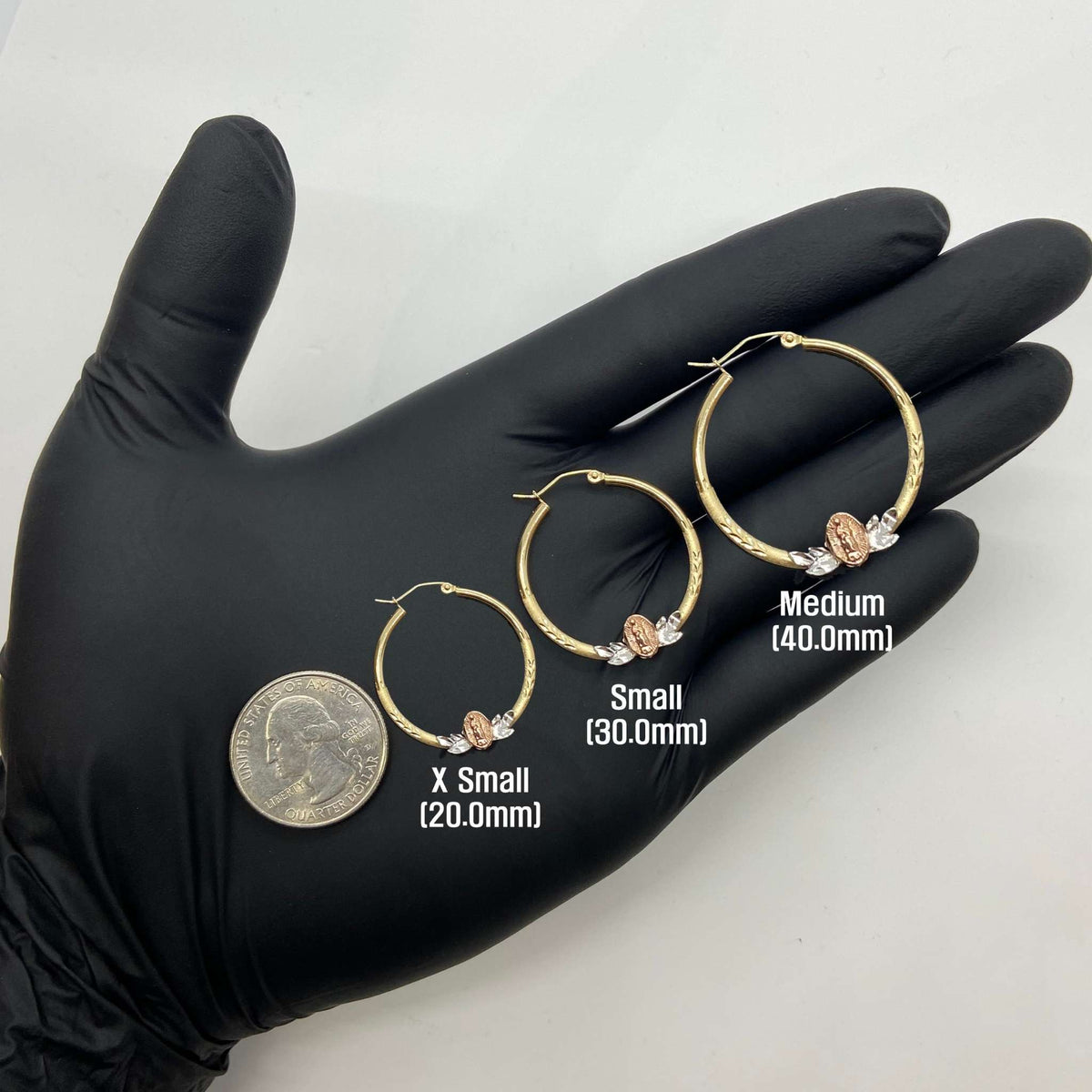 14k gold Virgin Mary hoop earrings in three sizes shown with a U.S. quarter.
