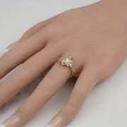 Tricolor gold turtle ring with CZ accents worn on a hand.