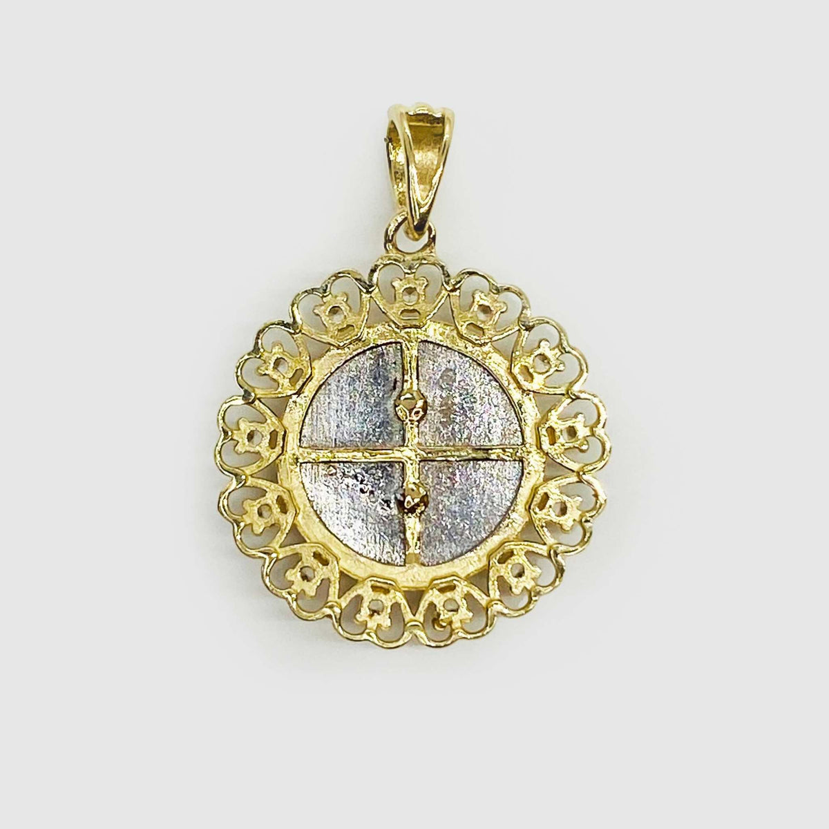 Front close-up view of the back of a 14k gold tri-color Virgin Mary round medallion pendant.