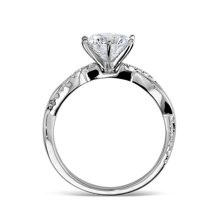 Side profile view of a white gold engagement ring with a twisted band.