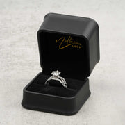 White gold diamond ring set presented inside an open black Nolters Gold jewelry box.