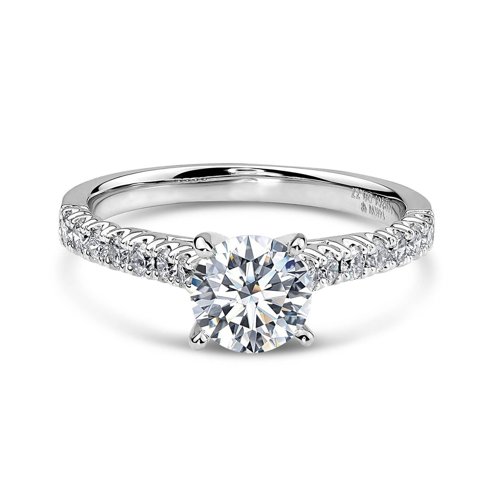14k white gold engagement ring with a round diamond and a pavé band.
