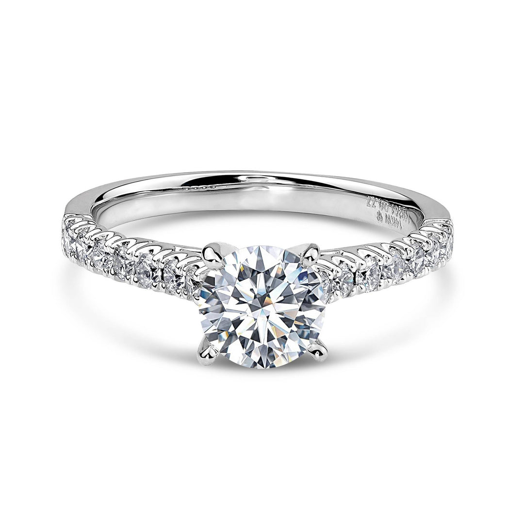 14k white gold engagement ring with a round diamond and a pavé band.