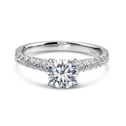 14k white gold engagement ring with a round diamond and a pavé band.