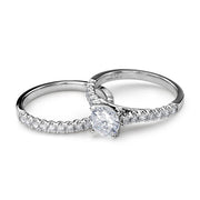14k white gold round lab-grown diamond engagement ring and matching pavé wedding band.