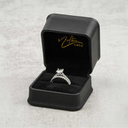 White gold diamond ring set presented inside an open black Nolters Gold jewelry box.