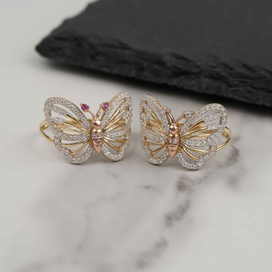 14k gold butterfly ring featuring cubic zirconia stones on a light marble surface