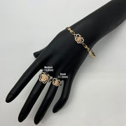 10k - 14k Gold butterfly bracelet and rings on a black mannequin hand with size labels.