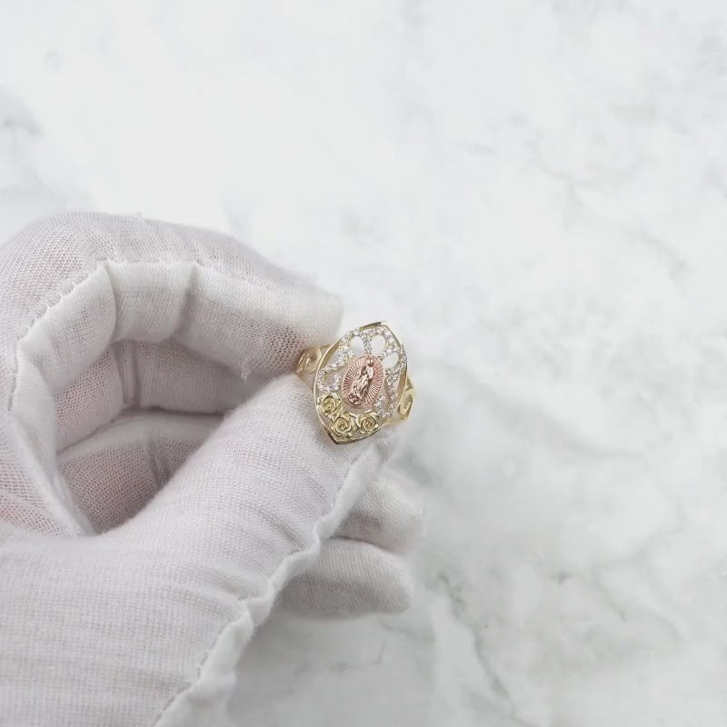 Gloved hand showcasing a rotating 10k and 14k gold Virgin Mary marquise ring.