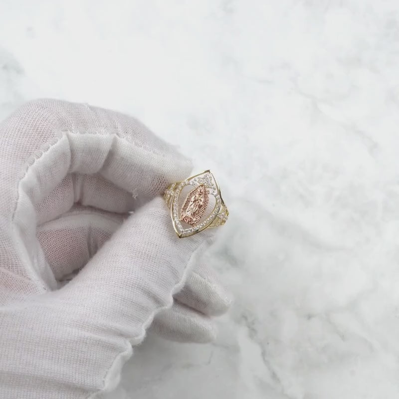White-gloved hand holding the 10k and 14k gold marquise Virgin Mary ring.