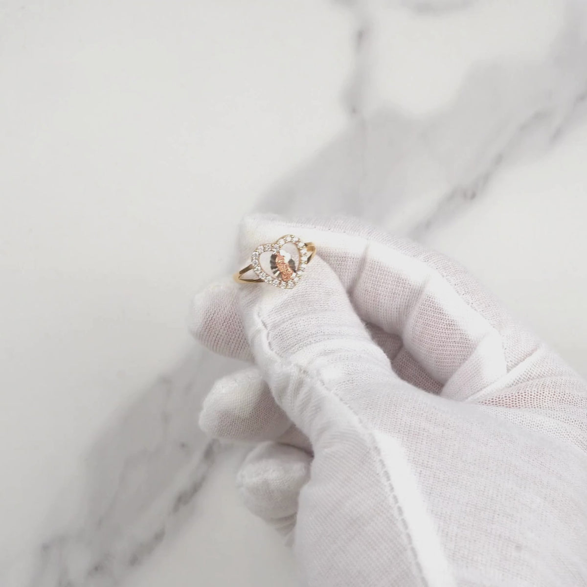 Video showcasing a gold Virgin Mary heart ring with sparkling cubic zirconia.