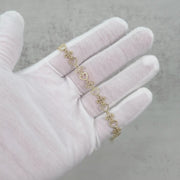 Video showing 10k yellow gold Amori nugget heart and cross bracelet on hand.